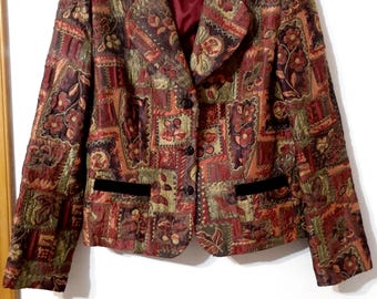 May include: A patterned blazer with a tapestry-like design in shades of burgundy, olive green, and gold. The blazer features a notched collar, two front pockets with black velvet trim, and three dark buttons. The interior lining is a deep red.