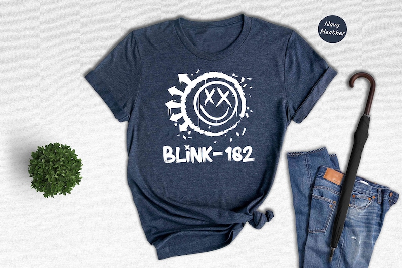 a t - shirt that says blink - 1932 next to a pair of jeans and