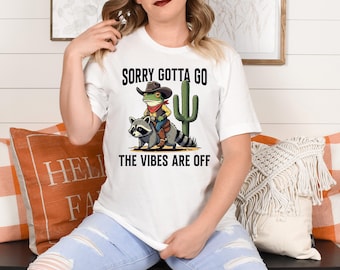 Cowboy Frog Riding Raccoon Shirt, The Vibes Are Off Weird Tee, Vintage Style Western Tee, Sarcastic Wild West Graphic Top, Animal Lover Gift