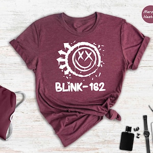 a t - shirt with the word blink - k - 12 on it next to