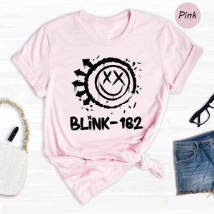 a pink shirt with a black and white graphic on it