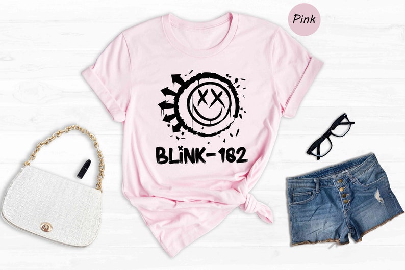 a pink shirt with a black and white graphic on it