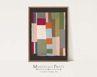 May include: A framed print of a colorful abstract quilt with geometric shapes in shades of pink, red, orange, green, blue, and gray. The quilt is framed in a dark wood frame with a black mat.