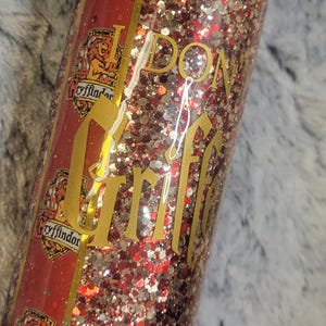 Cute Gryffindamn glitter tumbler with vinyl