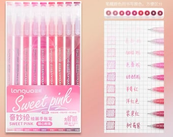 May include: A set of eight pink gel pens with a variety of shades, including blush, rose, and magenta. The pens are labeled "Sweet Pink" and are packaged in a pink box with the text "Languo" and "Sweet Pink" in Chinese characters. The pens are arranged in a row, with the tips of the pens facing the viewer. The box is on a white background.