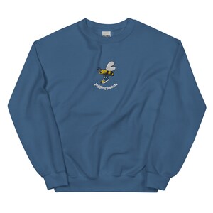 May include: A blue sweatshirt with a yellow and black bee wearing sneakers and the text "Jogging Jackets" embroidered on the front.