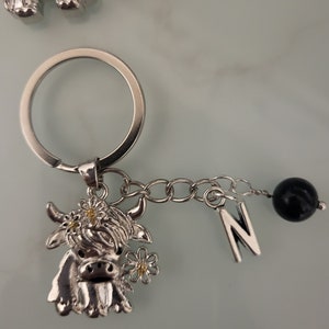 Highland cow keyring/keychain with initial and obsidian ball.
