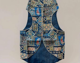May include: A blue sleeveless vest with a gold trim and a paisley pattern. The vest has a mandarin collar and a button closure.