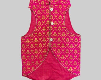May include: A pink sleeveless waistcoat with a gold floral pattern and a high collar. The waistcoat has a button closure and a slightly longer back.