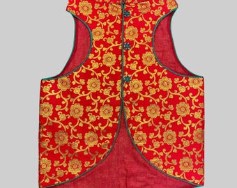 May include: A red sleeveless vest with a gold floral pattern and green trim. The vest has a mandarin collar and a single button closure.