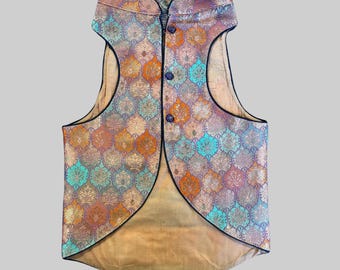 May include: A sleeveless waistcoat with a mandarin collar and a patterned design. The waistcoat is made of a brocade fabric with a teal, orange, and gold colour scheme. The waistcoat has a pointed hemline and a black trim.