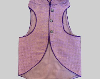 May include: A purple brocade waistcoat with a mandarin collar and a row of decorative buttons. The waistcoat has a long, pointed back.