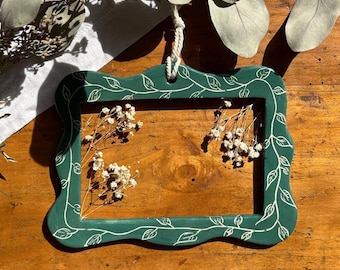 White stoneware or red clay frame, with sgraffito decoration