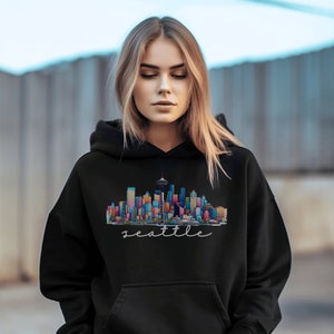 A Seattle sweatshirt with a colorful rendition of the city's skyline and the name Seattle in text. Available as a crewneck sweatshirt or hoodie.