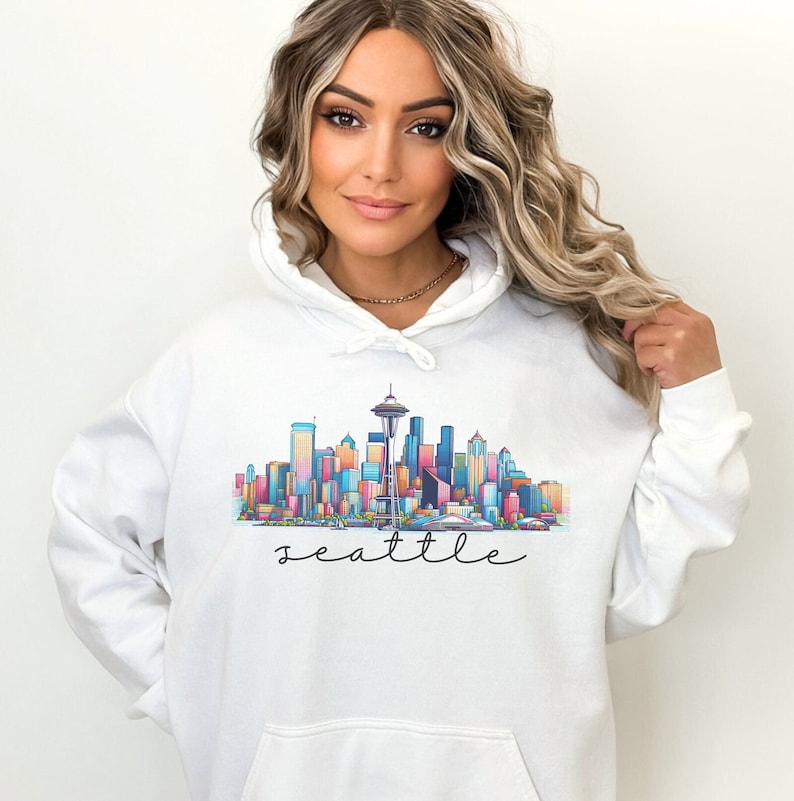 A Seattle sweatshirt with a colorful rendition of the city's skyline and the name Seattle in text. Available as a crewneck sweatshirt or hoodie.