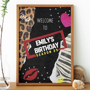 May include: A framed sign with a black background and a collage of patterns, including leopard print, zebra stripes, and a pink heart. The sign reads "WELCOME TO EMILY'S BIRTHDAY SEASON 25" in white and red text. Decorative elements include white stars and a red lip print.