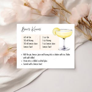 May include: A recipe card for a cocktail named "Bee's Knees" with a yellow cocktail illustration. The card lists ingredients in both metric and imperial measurements, including gin, honey, and lemon juice. Instructions are also provided.