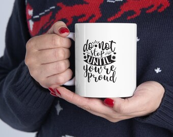 May include: White ceramic coffee mug with black text that reads "do not stop until you're proud".