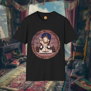 Puede incluir: Camiseta negra con un gráfico circular de una deidad con un halo azul, detalles intrincados y un borde rosa y marrón. El gráfico está centrado en la camiseta. Cuello redondo y mangas cortas.