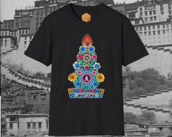 May include: Black t-shirt featuring a colorful, ornate design with floral and geometric elements. The design includes a central figure and the text "Om Mani Padme Hum". The shirt has a crew neck and short sleeves.