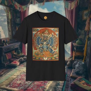 Puede incluir: Camiseta negra con un gráfico colorido de una deidad. El diseño incorpora tonos azules, rojos y dorados. La camiseta tiene cuello redondo y mangas cortas, ideal para el uso diario. La obra de arte es detallada.