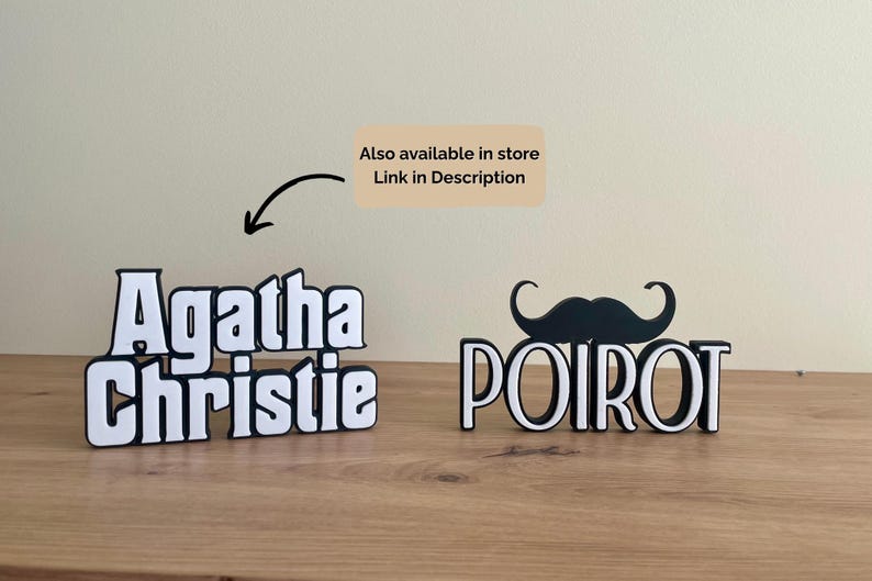 Pu&ograve; includere: Due insegne con nomi 3D in bianco e nero, una con la scritta "Agatha Christie" e l'altra "Poirot" con un paio di baffi. Le insegne sono su una superficie di legno. &Egrave; visibile anche il testo "Also available in store Link in Description".