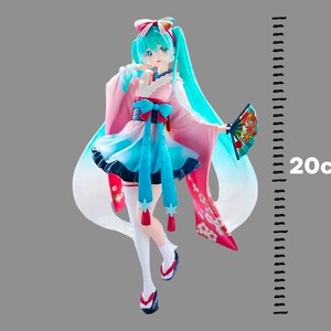 Hatsune Miku kawaii girl figure displayed with other anime collectibles