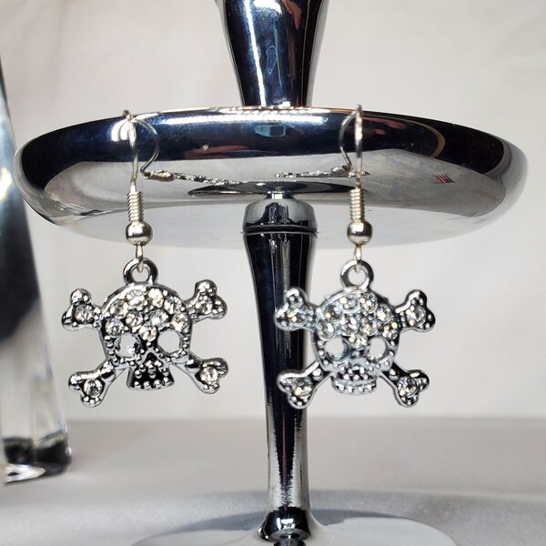 Crystal skull and crossbones earrings. Rhinestone and alloy. Nickel free earring hoops with rubber backs.