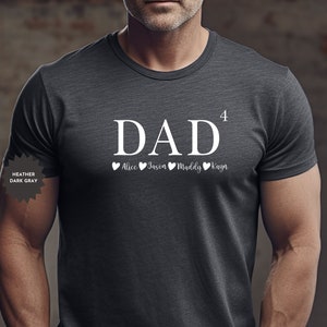 May include: Heather dark gray t-shirt with the word "DAD" and the number "4" above it. Below the word "DAD" are four hearts with the names "Alice", "Jason", "Maddy", and "Kayn" written below each heart.