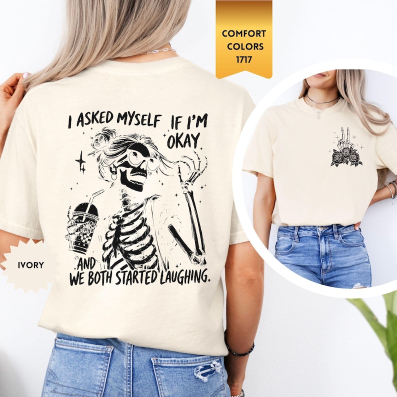 May include: Ivory t-shirt with a skeleton graphic and the text "I asked myself if I'm okay, and we both started laughing." The design includes a skeleton holding a drink and a peace sign on the back.