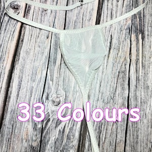May include: A light green thong with a delicate, sheer fabric. The thong features thin straps and a small, triangular front panel. The text "33 Colours" is displayed in a pink font.