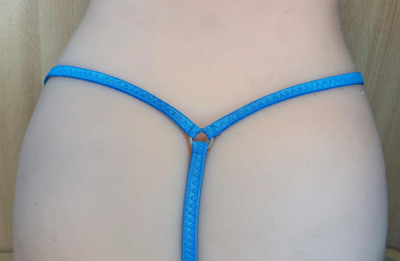 May include: A blue thong with a metal ring in the back.