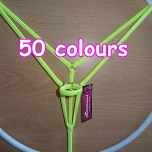 May include: A lime green harness with a gold ring and a small tag that says "Jovanadesign". The harness is attached to a white hoop. The text "50 colours" is written in pink on the image.