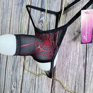 May include: A set of three ceramic mugs with a speckled, cream-colored glaze. Each mug features a different hand-painted floral design in shades of blue, green, and yellow. The mugs have a simple, modern shape with a comfortable handle.