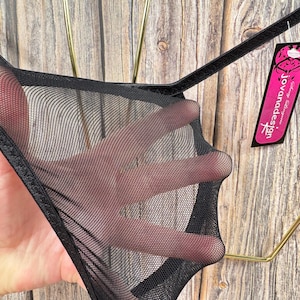 May include: Black mesh lingerie with a satin trim. The tag reads "Jovanadesign".