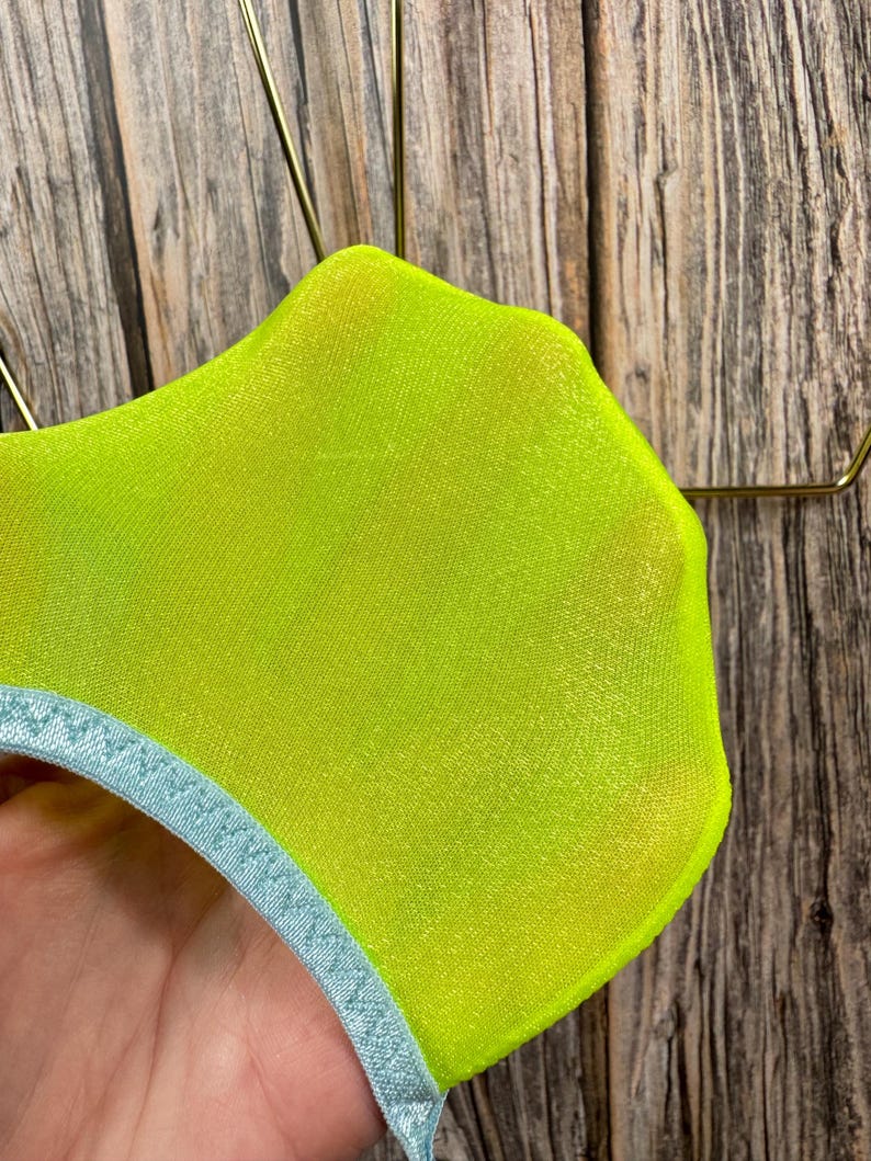 May include: A pair of neon yellow sheer socks with a light blue trim around the top.