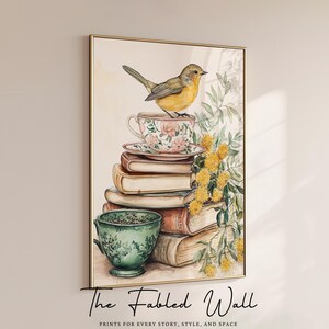 A whimsical printable art print featuring a yellow songbird perched atop a floral teacup, resting on a charming stack of vintage books with a green teacup beside it and sprigs of yellow wildflowers—perfect for cozy cottagecore or book-themed decor.