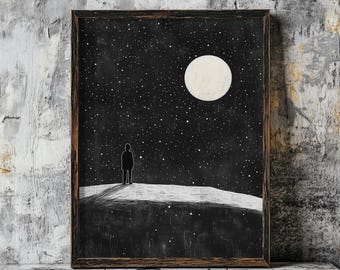 May include: A black and white illustration of a person standing on a hilltop looking at a large, white moon in a starry night sky. The image is framed in a dark wood frame.