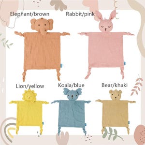 May include: Five baby security blankets with animal heads: an elephant, rabbit, lion, koala, and bear. Each blanket is a different color, including brown, pink, yellow, blue, and khaki. The blankets have knotted arms and legs.