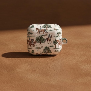 Protective AirPods Case Horse Design Pattern Equestrian Style Cover Scratch Resistant Polycarbonate Material Gloss Finish Detail Carabiner Attachment Included Slim Lightweight Construction Horse Girl Gift Idea Country Aesthetic Appeal Cream