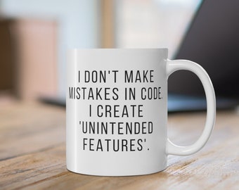Programmer Mug: I don't make mistakes in code. I create 'unintended features' - Ceramic Mug