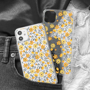 May include: Two clear phone cases with a floral pattern in yellow and white. The cases are in a jean pocket.