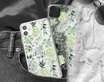 Könnte beinhalten: Eine transparente Handyhülle mit grünem Blumenmuster. Die Hülle befindet sich in einer Gesäßtasche einer schwarzen Jeans.