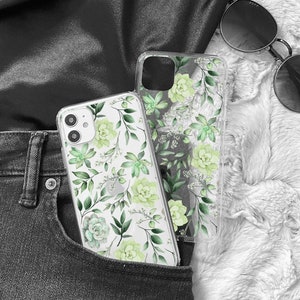 May include: A clear phone case with a green floral pattern. The case is in a back pocket of a pair of black jeans.