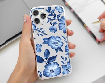 May include: A clear phone case with a blue floral pattern. The case is designed for an iPhone with a triple lens camera.