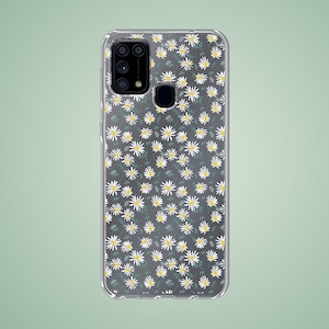 Può includere: Una custodia per telefono trasparente con un motivo di margherite bianche. La custodia ha un ritaglio per l'obiettivo della fotocamera.