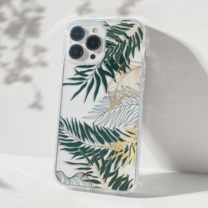 May include: A clear phone case with a tropical leaf design. The leaves are green and gold and have a detailed outline.