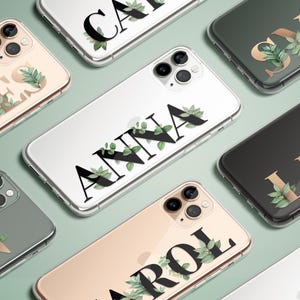 May include: A collection of phone cases with different names printed on them. Each case has a floral design with green leaves and gold accents. The names on the cases are James, Anna, Carol, Lena, Skye, and Grace.