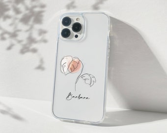 May include: Clear phone case with a botanical design featuring two leaves in a line art style with a watercolor effect in pink and peach. The name "Barbara" is written in script.