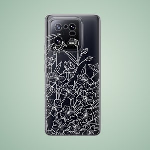Può includere: Una custodia per smartphone nera con un design floreale bianco. La custodia ha un rialzo per la fotocamera con la scritta "LEICA" stampata su di essa.